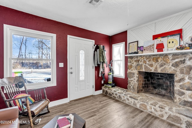 living room with a fireplace and hardwood / wood-style flooring