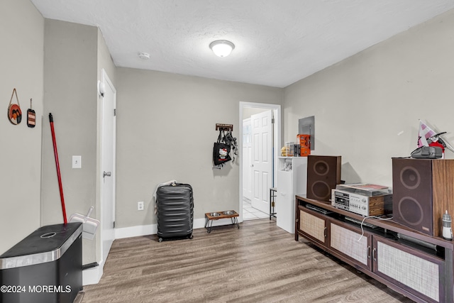 misc room with hardwood / wood-style floors and a textured ceiling