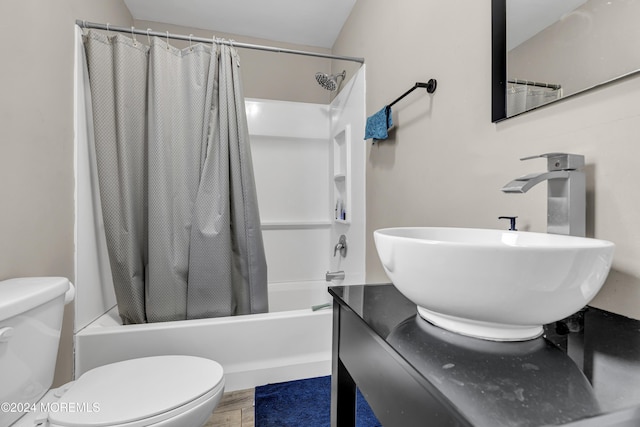 full bathroom featuring hardwood / wood-style floors, toilet, shower / bath combo, and sink