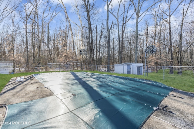 view of pool with a yard