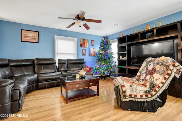 living room featuring ceiling fan and light hardwood / wood-style floors