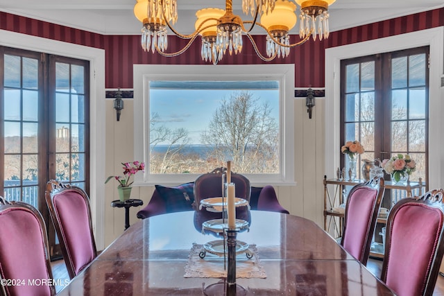 dining space with a chandelier, plenty of natural light, and french doors