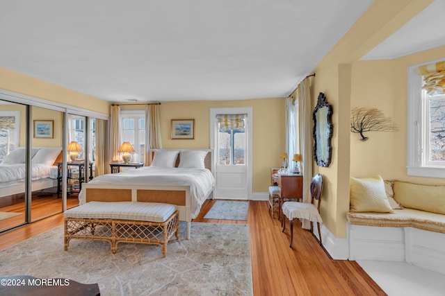 bedroom with light wood-type flooring and baseboards