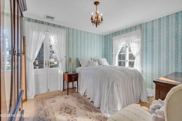 bedroom with wallpapered walls, an inviting chandelier, visible vents, and ornamental molding