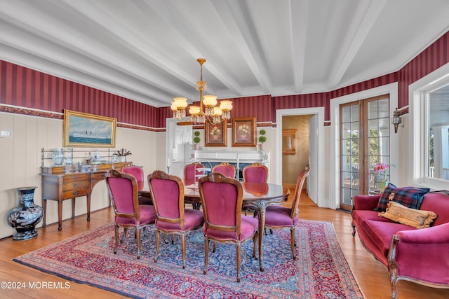 dining space featuring wood finished floors, french doors, beam ceiling, and a chandelier