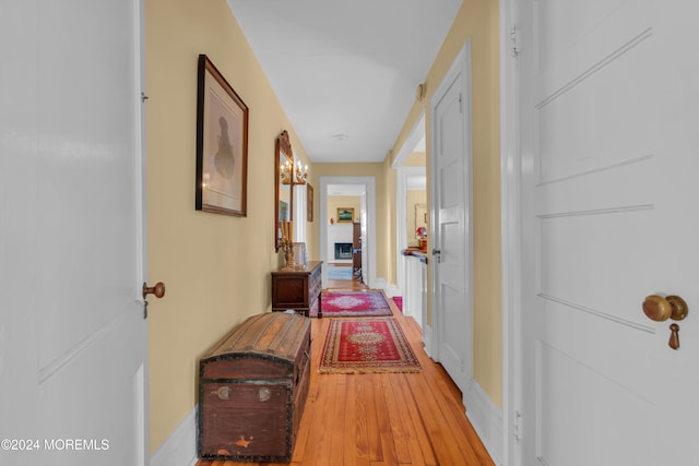 hallway with wood finished floors and baseboards