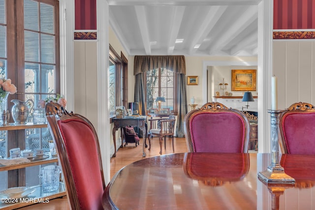 dining space featuring beamed ceiling and wood finished floors