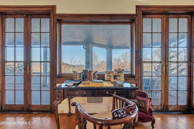 office space featuring french doors, plenty of natural light, and hardwood / wood-style floors