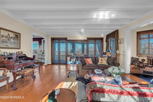 living area featuring beamed ceiling, french doors, and wood finished floors