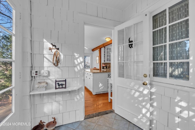 interior space featuring light tile patterned floors and tile walls