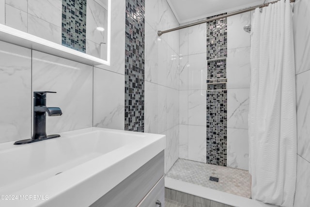 bathroom with a shower with shower curtain, vanity, and tile walls