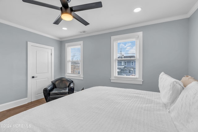 bedroom with ceiling fan, crown molding, dark wood-type flooring, and multiple windows