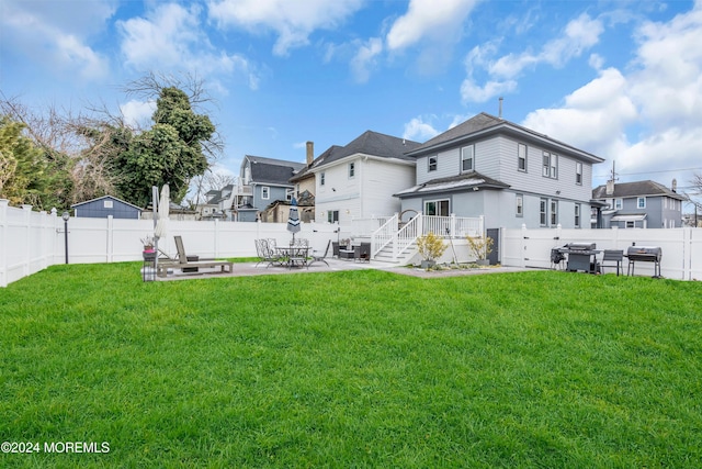 back of house with a yard and a patio area