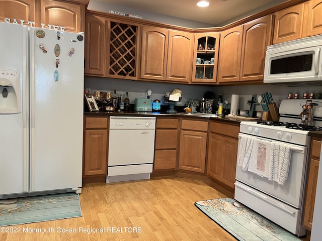 kitchen with light wood-type flooring and white appliances