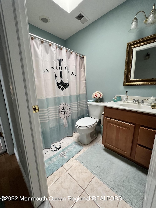 bathroom featuring tile patterned floors, vanity, and toilet