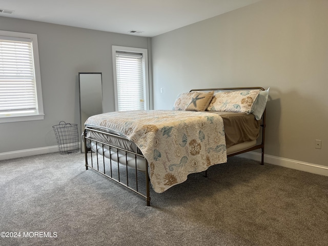 bedroom with dark colored carpet