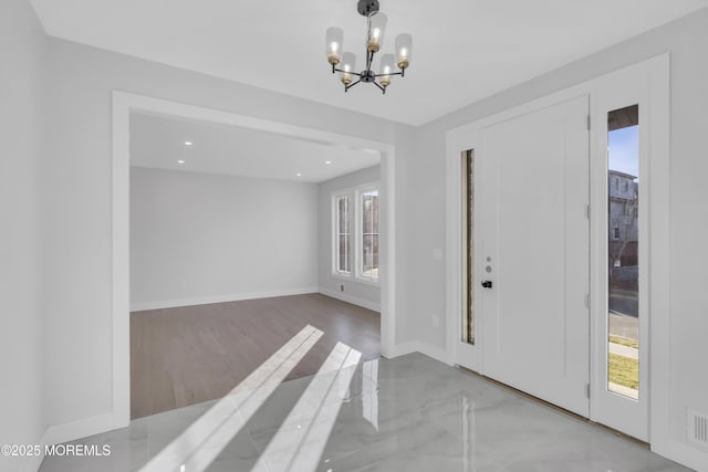 entrance foyer featuring an inviting chandelier