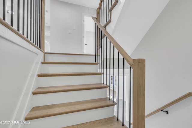 staircase featuring wood-type flooring