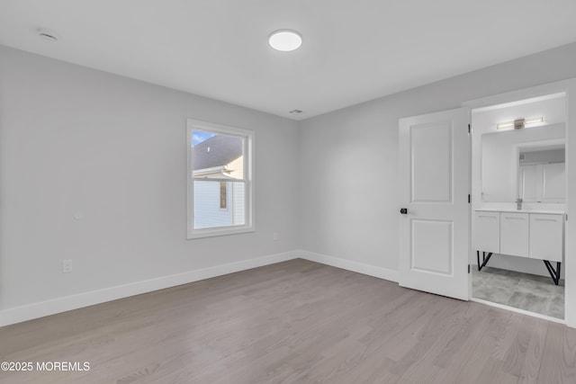 unfurnished room with light wood-type flooring