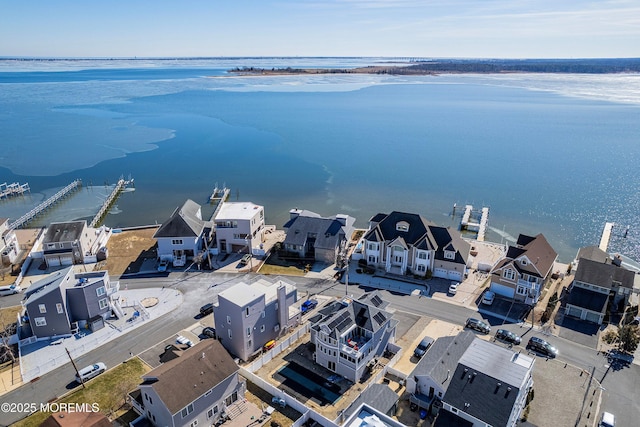 bird's eye view featuring a water view and a residential view