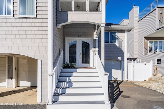 entrance to property with a garage and french doors