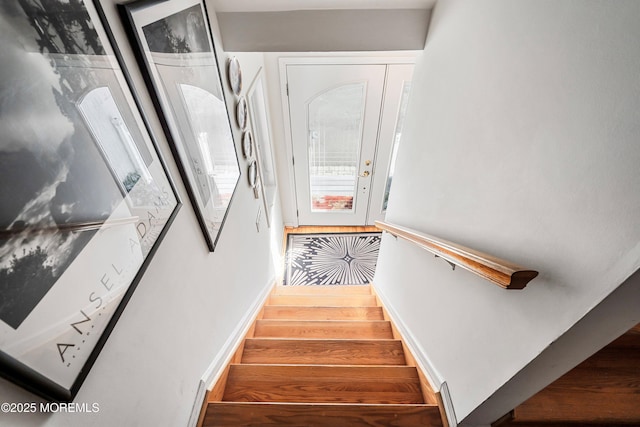 stairway featuring wood finished floors