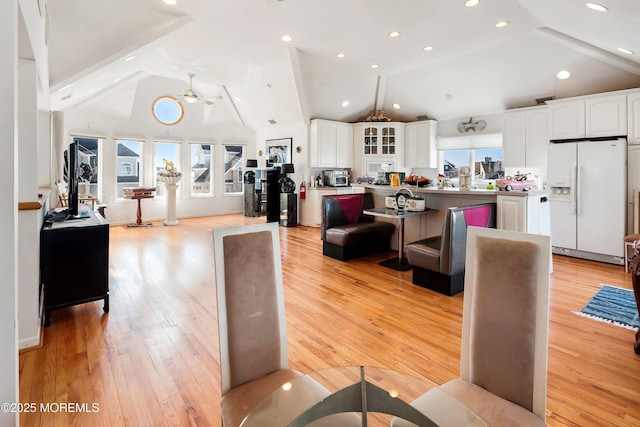 living room featuring light wood-style floors, recessed lighting, high vaulted ceiling, and a ceiling fan