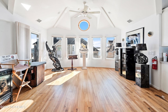 exercise area featuring high vaulted ceiling, a ceiling fan, visible vents, and hardwood / wood-style floors