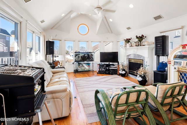 living room featuring wood finished floors, visible vents, and a ceiling fan