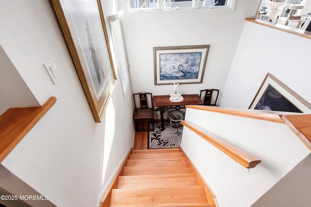 staircase with wood finished floors