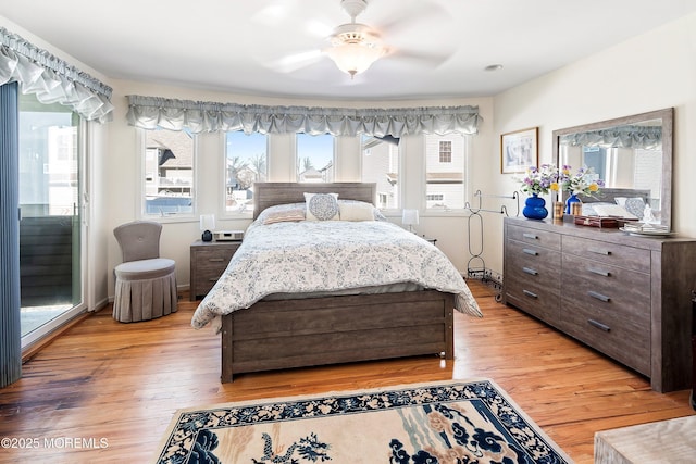 bedroom featuring light wood-type flooring, ceiling fan, and baseboards