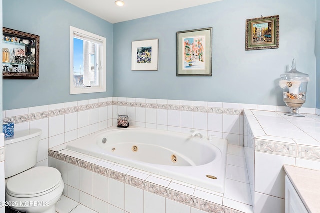 bathroom with toilet, vanity, and a whirlpool tub