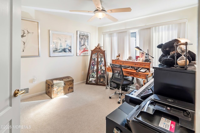 carpeted office featuring ceiling fan and baseboards