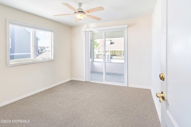 empty room featuring carpet, a ceiling fan, and baseboards