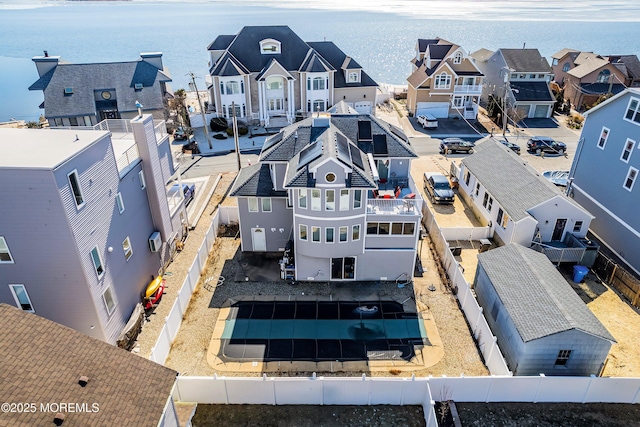 drone / aerial view with a residential view and a water view