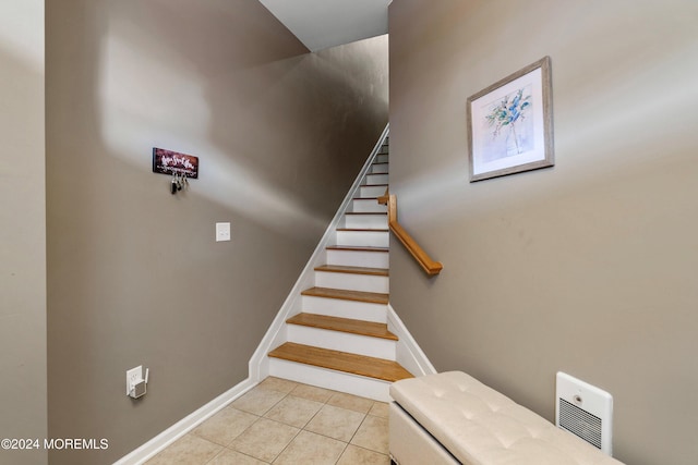 stairs featuring tile patterned floors