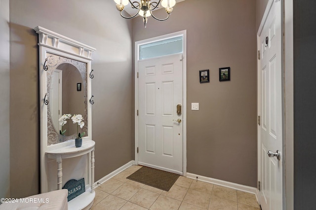 tiled foyer entrance featuring a notable chandelier