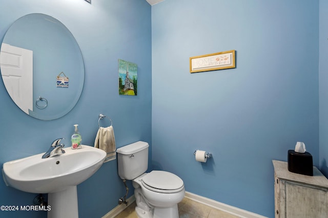 bathroom featuring tile patterned floors, sink, and toilet