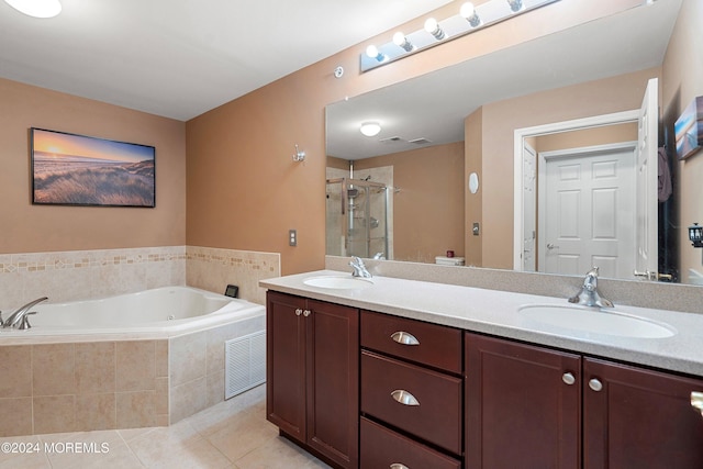 bathroom with plus walk in shower, vanity, and tile patterned floors