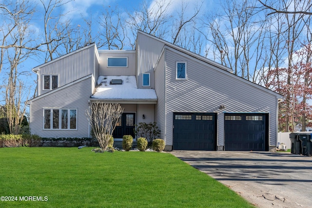 view of front of house with a front yard and a garage