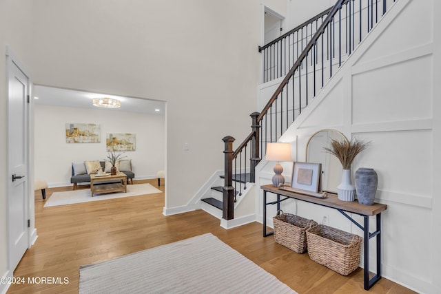 entrance foyer with a high ceiling and hardwood / wood-style flooring