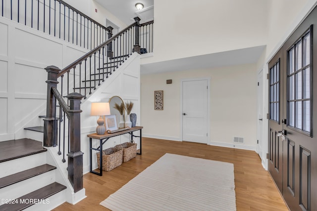 foyer featuring a high ceiling and light wood-type flooring