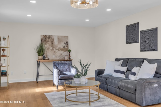 living room with light hardwood / wood-style flooring and a chandelier