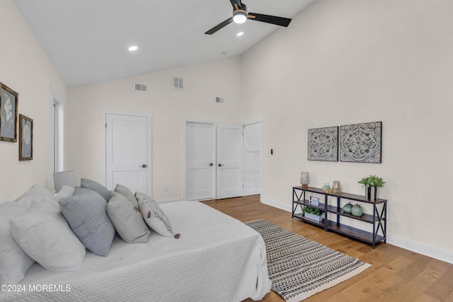 bedroom featuring hardwood / wood-style floors, ceiling fan, and high vaulted ceiling