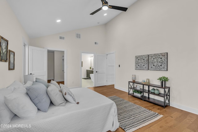 bedroom featuring connected bathroom, ceiling fan, high vaulted ceiling, and wood-type flooring