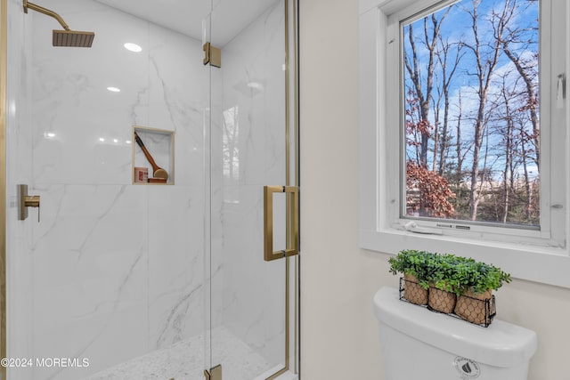 bathroom featuring toilet and walk in shower