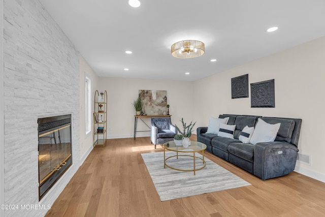 living room featuring a fireplace and light hardwood / wood-style floors