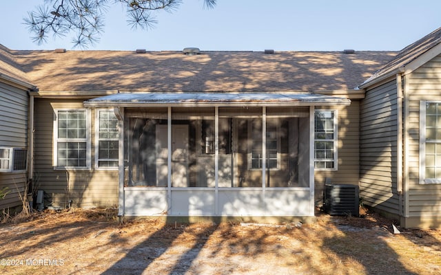 view of side of home featuring a sunroom and central air condition unit