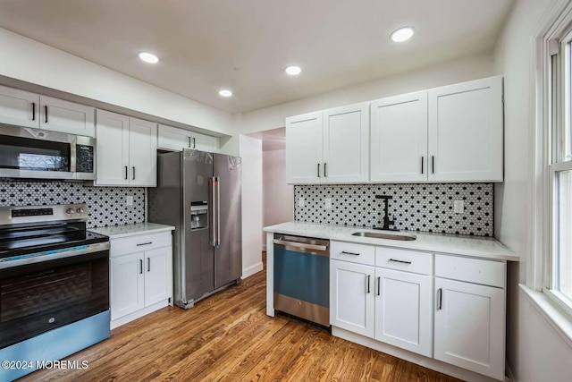 kitchen featuring sink, white cabinets, and appliances with stainless steel finishes