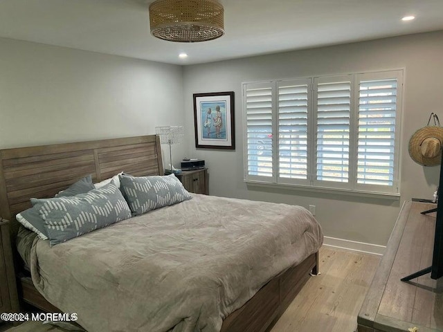 bedroom featuring light hardwood / wood-style flooring and multiple windows